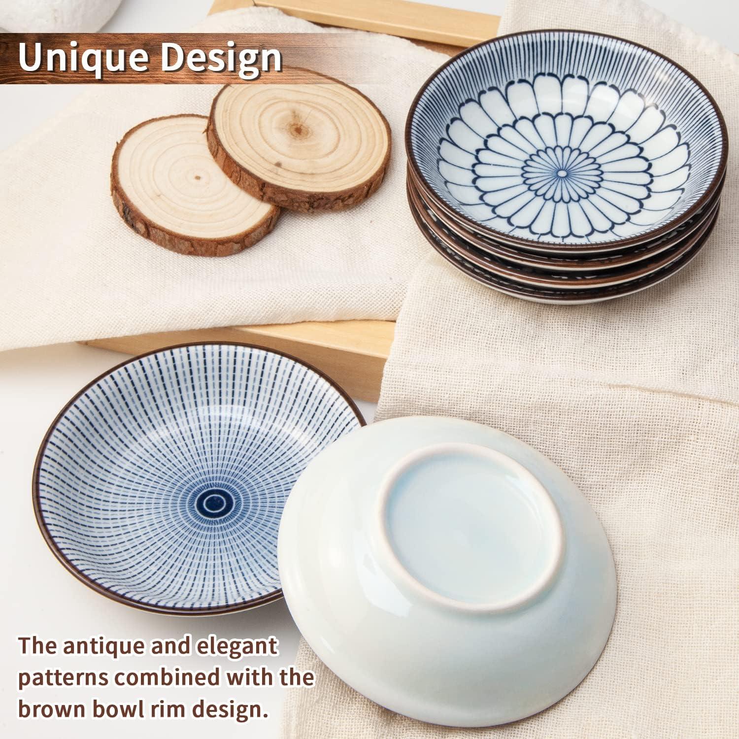 Set of vintage blue ceramic dipping bowls with antique patterns and brown rims on fabric and wooden coasters