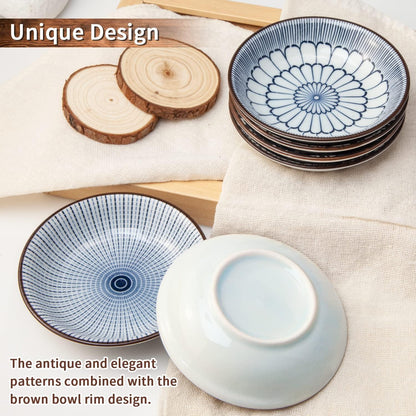 Set of vintage blue ceramic dipping bowls with antique patterns and brown rims on fabric and wooden coasters