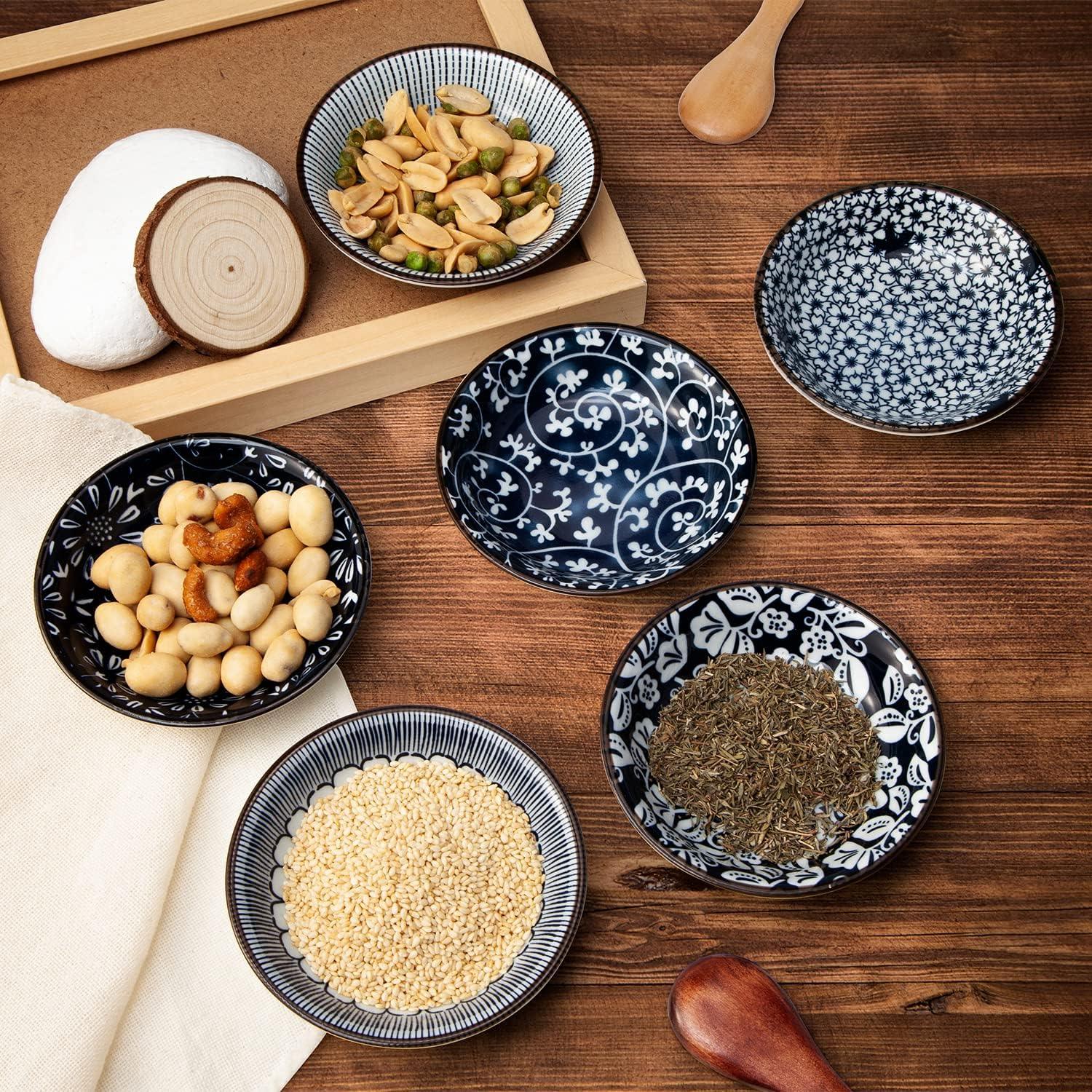 Set of six small vintage blue ceramic dipping bowls with assorted nuts, seeds, and herbs on wooden table