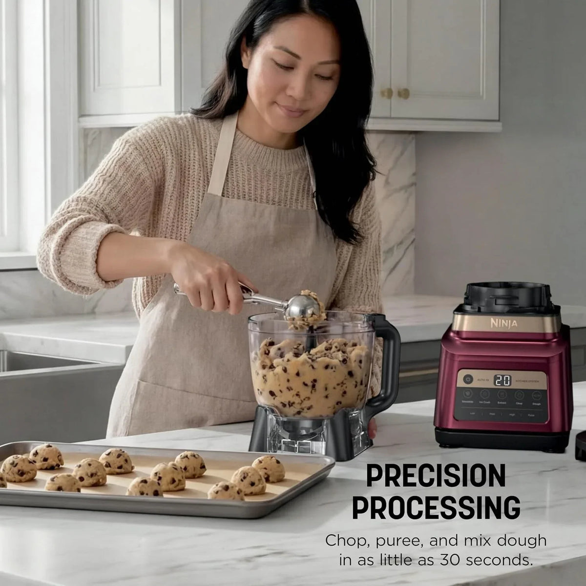 woman-using-a-ninja-food-processor-to-make-chocolate-chip-cookie-dough-in-a-kitchen