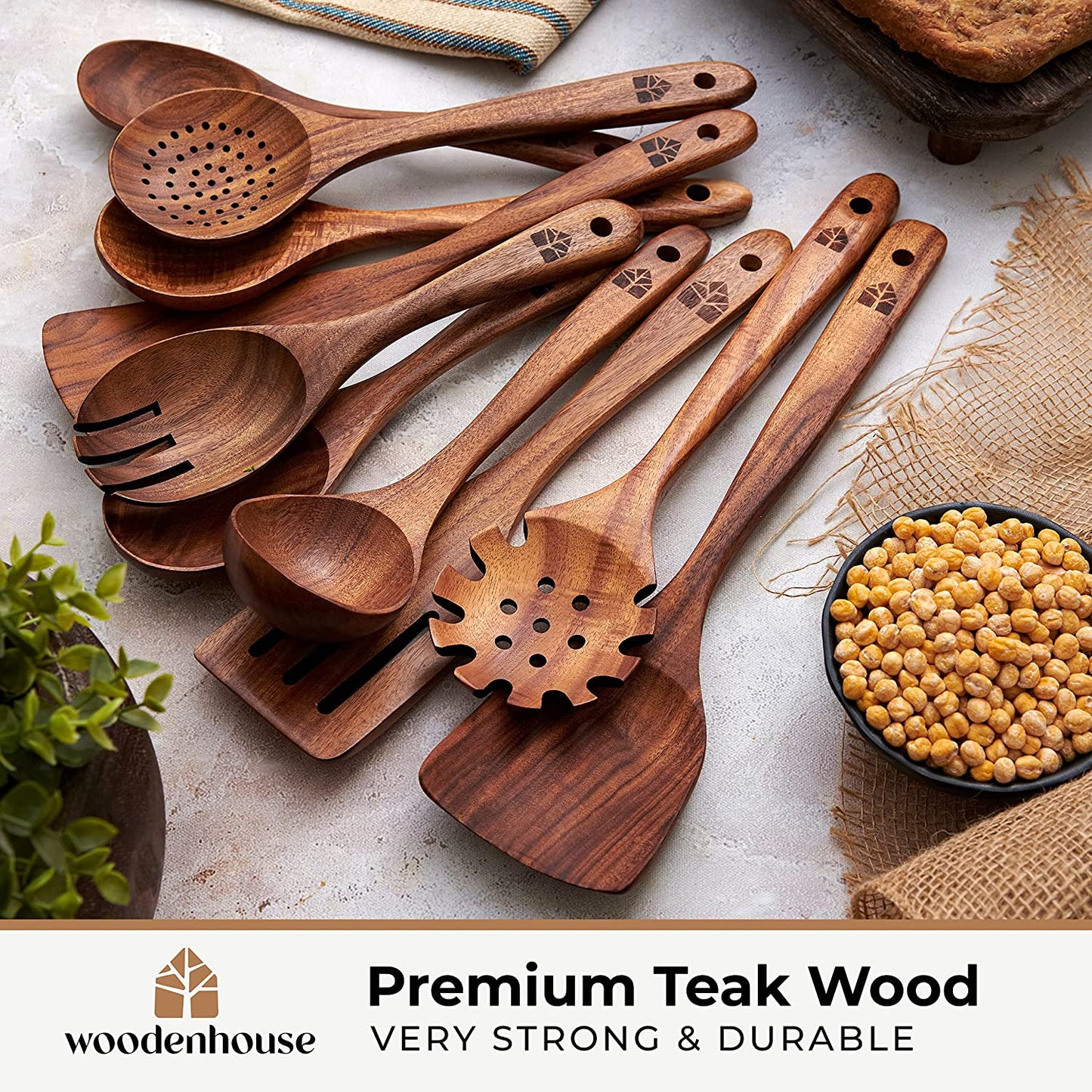 Teak wood flat frying spatula and wok spatula lying on a wooden cutting board.