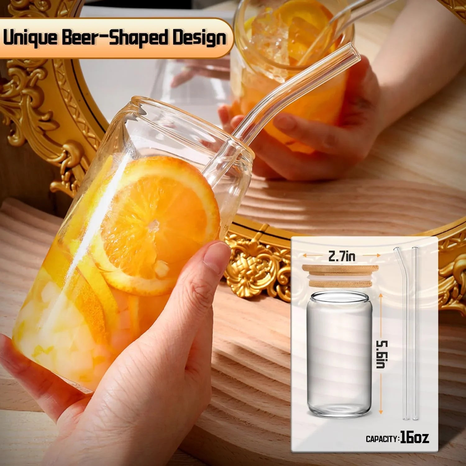 Hand holding 16 oz glass tumbler with lid and straw filled with iced orange drink, beer-shaped design
