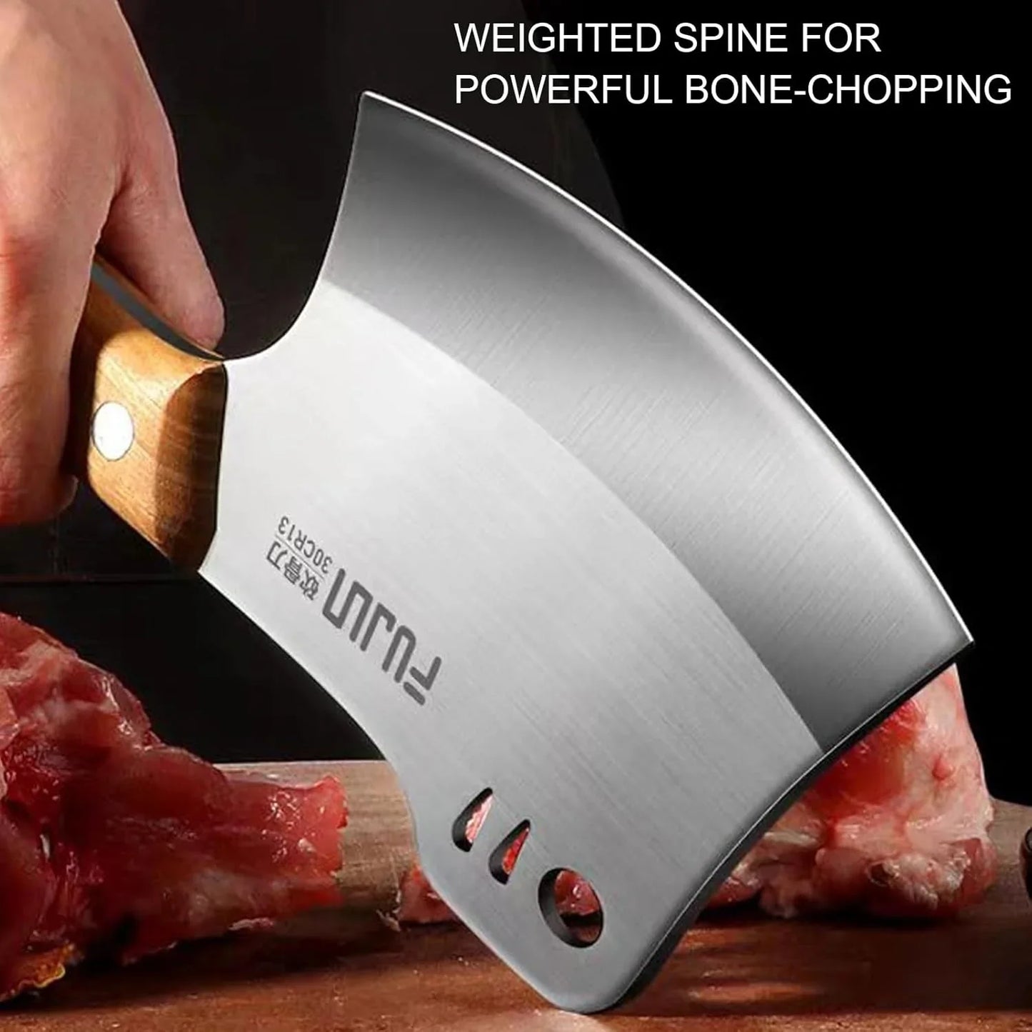 Hand holding heavy-duty meat cleaver with wooden handle chopping raw meat and bone