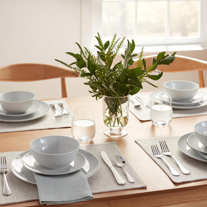 White porcelain dinnerware set shown inside a microwave to highlight microwave-safe use.