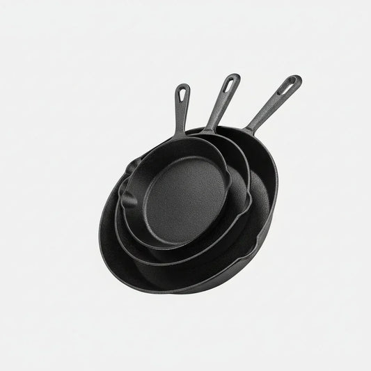 Set of three pre-seasoned cast iron skillets in 6, 8, and 10-inch sizes stacked on white background