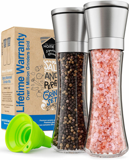 Premium stainless steel and glass salt and pepper grinder set of two on a kitchen counter.