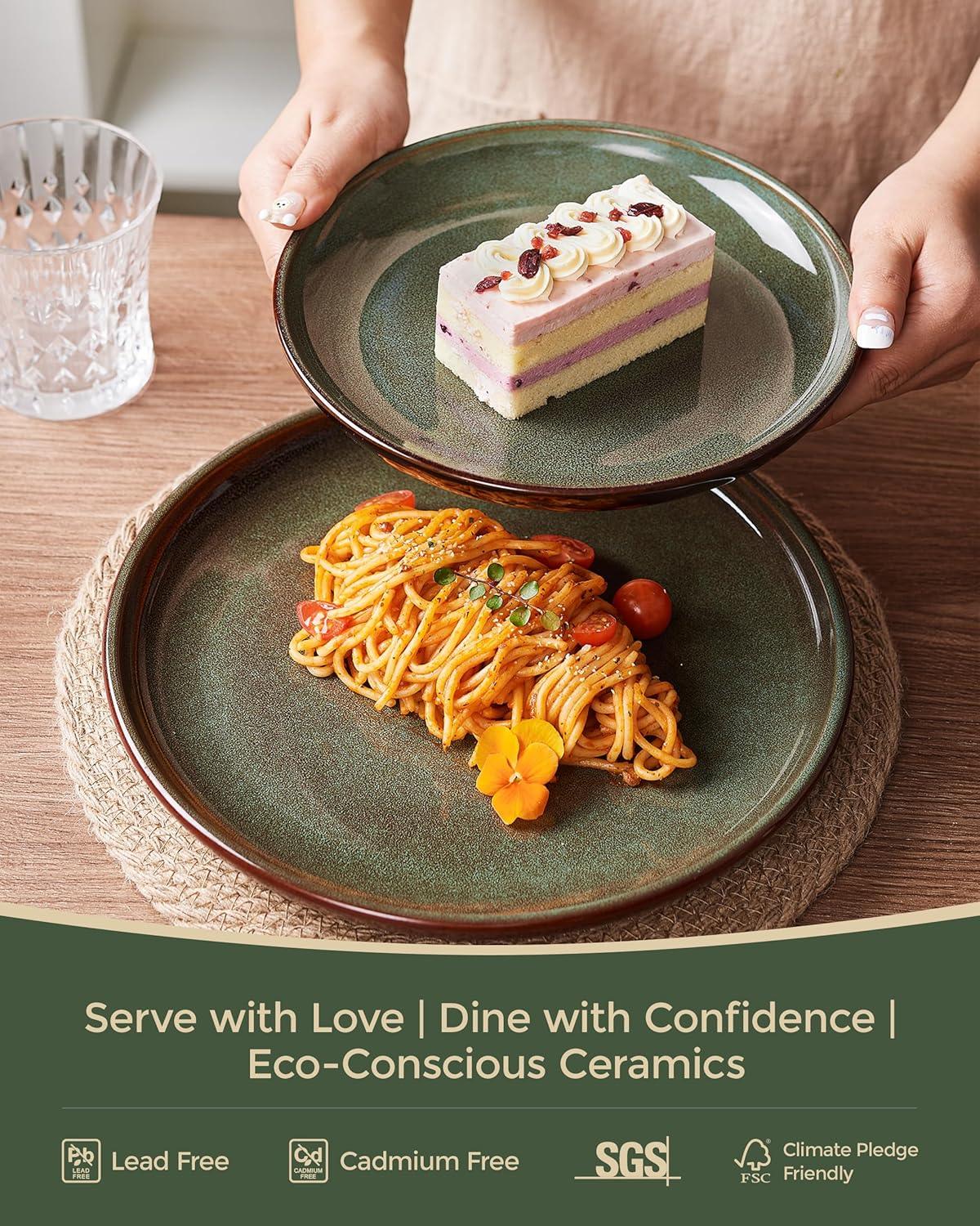 Hand holding a green reactive glaze stoneware plate with dessert above another plate with spaghetti and cherry tomatoes