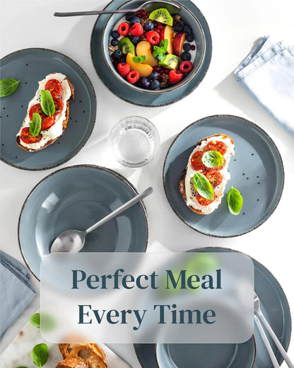 Rustic smoky blue stoneware dinnerware set with toast and fruit bowl on white table