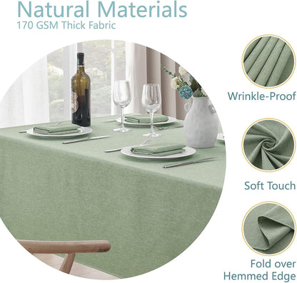 Sage green rectangular tablecloth covering a six-seat dining table with place settings.