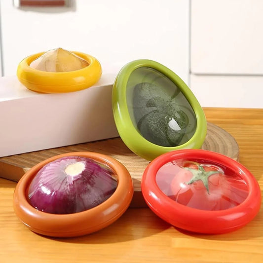 Four colorful kitchen storage containers with transparent lids on a wooden surface.