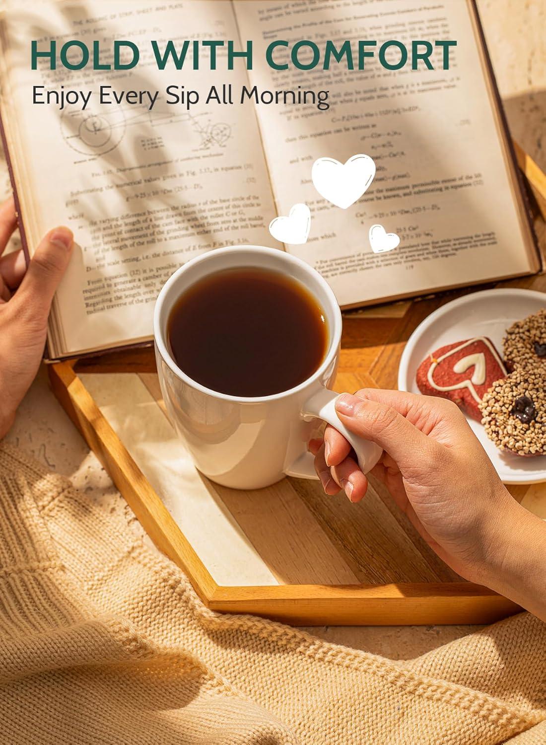 Hand holding white porcelain coffee mug on wooden tray with open book and cookies, cozy morning setup