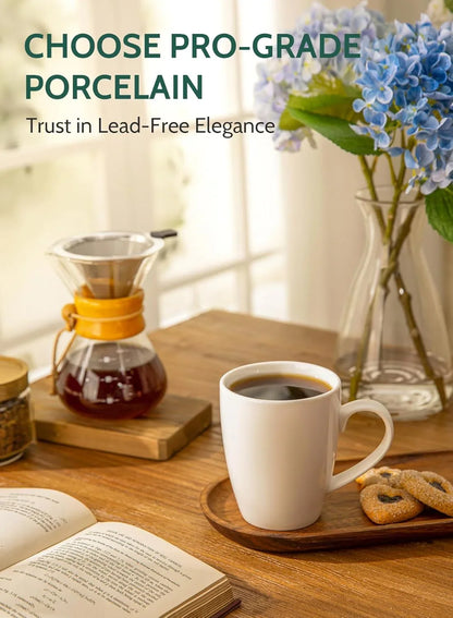 White porcelain coffee mug on wooden tray with cookies, coffee brewer, open book, and blue flowers
