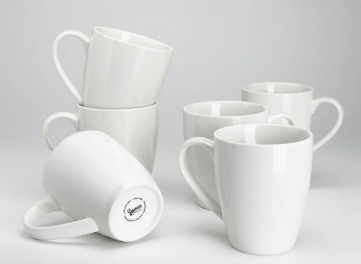 Set of six 16oz white porcelain coffee mugs with large handles on plain background