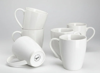 Set of six 16oz white porcelain coffee mugs with large handles on plain background