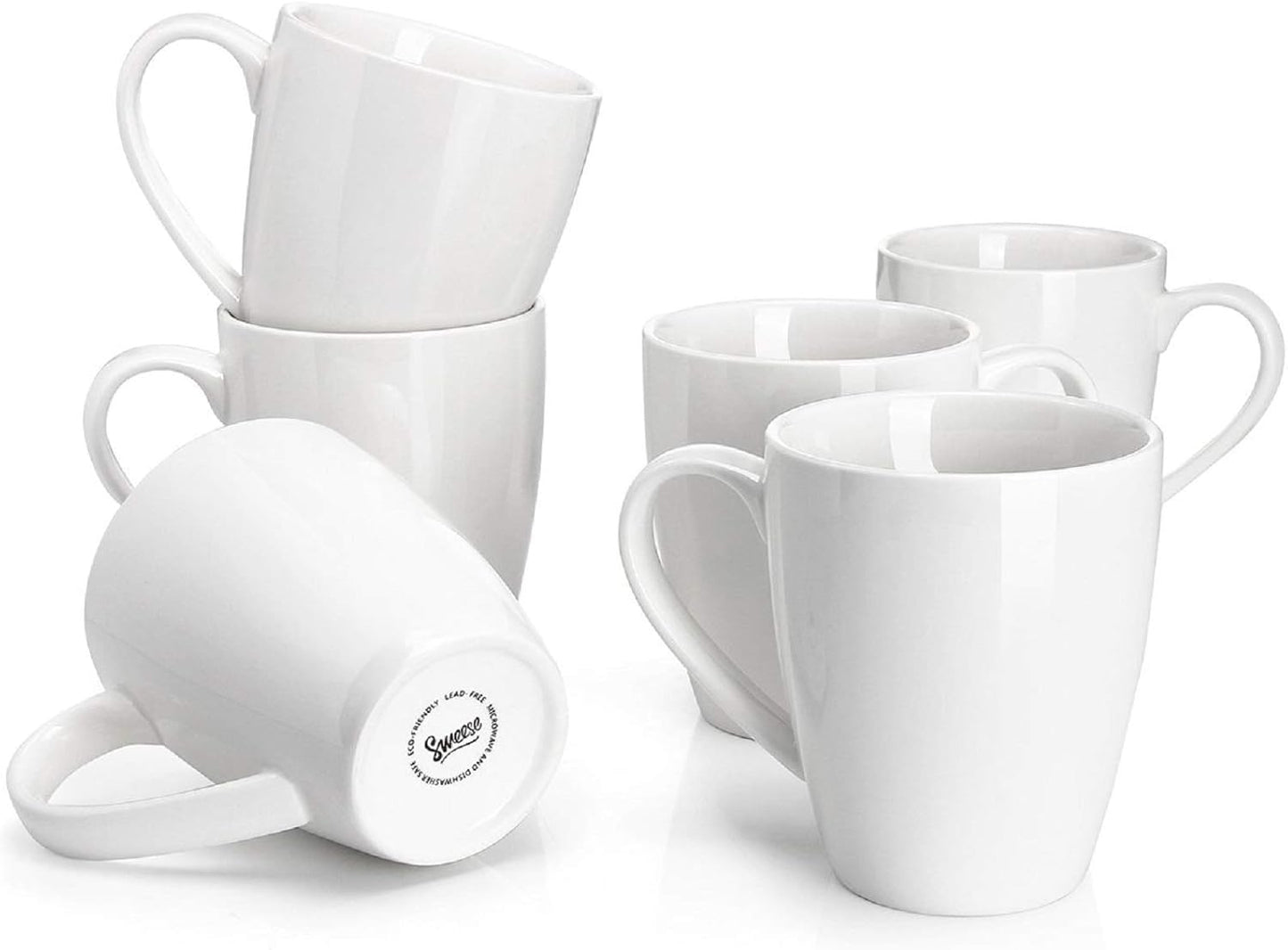 Set of six 16oz white porcelain coffee mugs arranged on a kitchen counter.