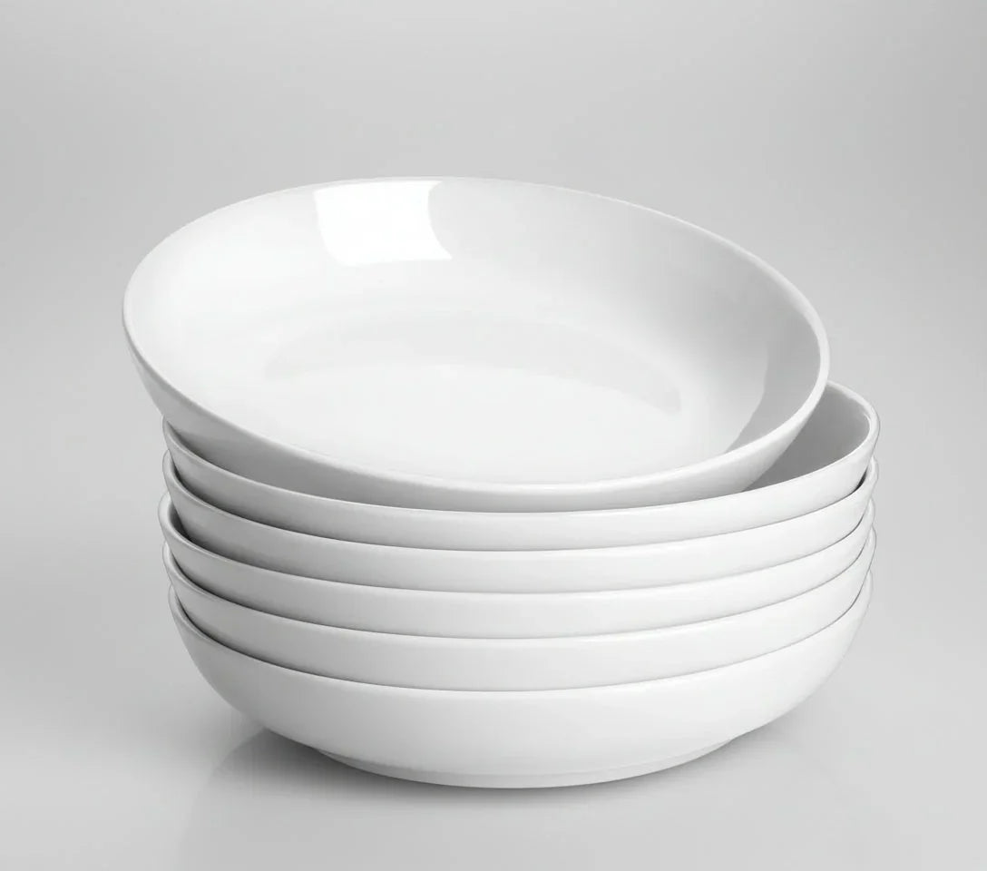 Stack of six white 30oz wide shallow porcelain pasta bowls on gray background