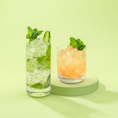 Side view of six straight highball glasses arranged in a neat row.