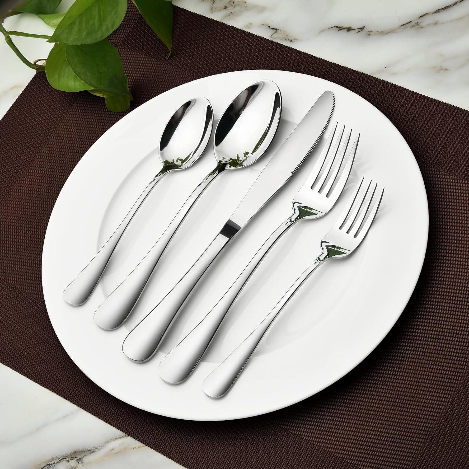 Heavy-duty stainless steel silverware set with spoons, forks, and knife on white plate, brown placemat