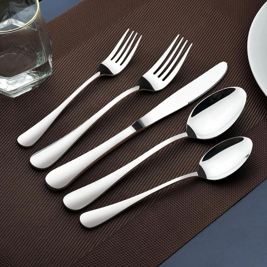  polished stainless steel flatware set with forks, knives, and spoons on brown placemat