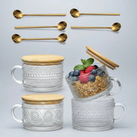 Set of four embossed glass mugs with bamboo lids and gold spoons, one mug with granola and berries