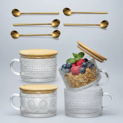 Set of four embossed glass mugs with bamboo lids and gold spoons, one mug with granola and berries