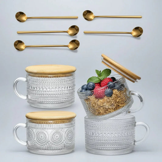 Set of four embossed glass mugs with bamboo lids and gold spoons, one mug with granola and berries