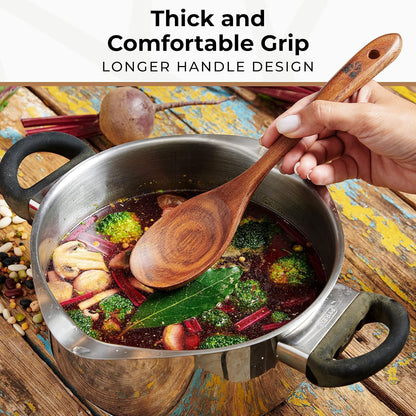 Teak wooden soup ladle and skimmer spoon resting on the edge of a cooking pot.